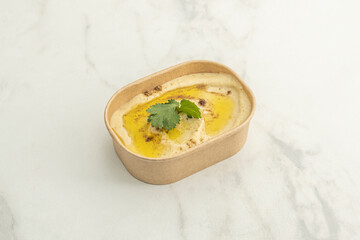 Hummus with sautéed minced lamb (hummus with lahme), presented with the meat in the center and garnished with toasted pine nuts