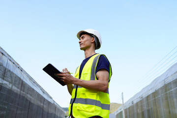 Construction, engineer and man with tablet for agriculture, project development and research. Greenhouse, black person and architect with thinking for maintenance, inspection and structural stability