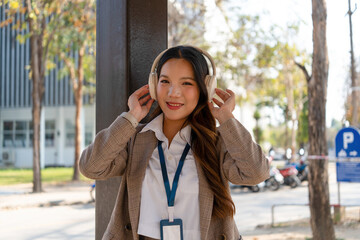 Asian businesswoman working on digital tablet with stylus outside modern building