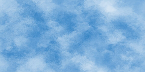 A beautiful clear blue sky is filled with fluffy white clouds, capturing the light of nature's summer day atmosphere