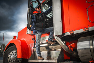 Man Steps out of Red Truck in Evening Light