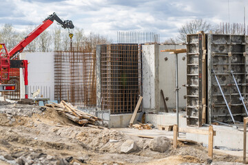 Construction Workers Build Walls With Crane at Site