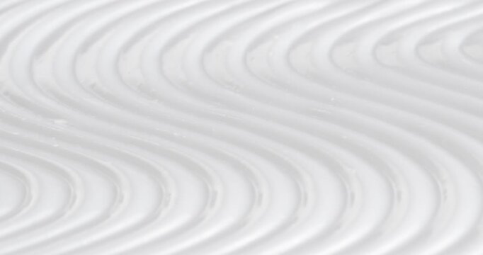 Cosmetic smears of creamy texture. Cosmetic skin cream. Beauty skincare product sample. Close-up footage of cream texture on rotating table