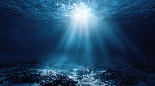 this is an underwater photograph showcasing a deep sea environment. the main focus of the image is a ray of sunlight shining down from above