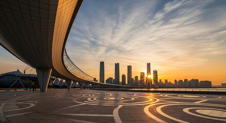 Modern bridge curves gracefully over a waterfront plaza with a vibrant cityscape at sunrise