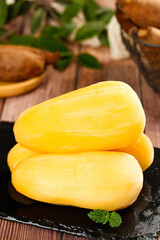 Fresh Yellow Mangoes on Black Slate with Mint Garnish