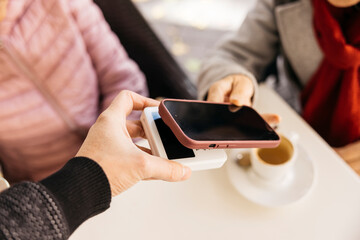 Customer making contactless mobile payment at point of sale terminal