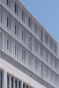 Modern architecture facade highlighting building windows and linear urban patterns in a detailed contemporary exterior composition