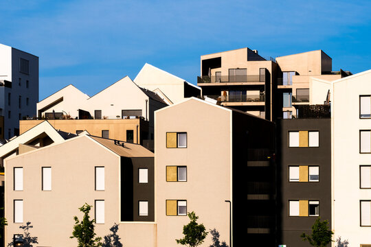 Modern residential architecture facade featuring urban building geometry symmetry and exterior daylight composition in a contemporary context