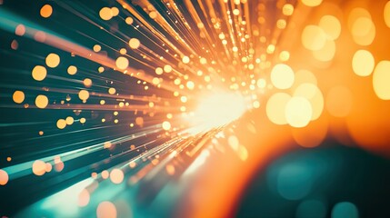 Abstract digital connectivity concept showing bright orange and yellow light particles and bokeh effects radiating from a central focal point, representing fast data transfer and information flow