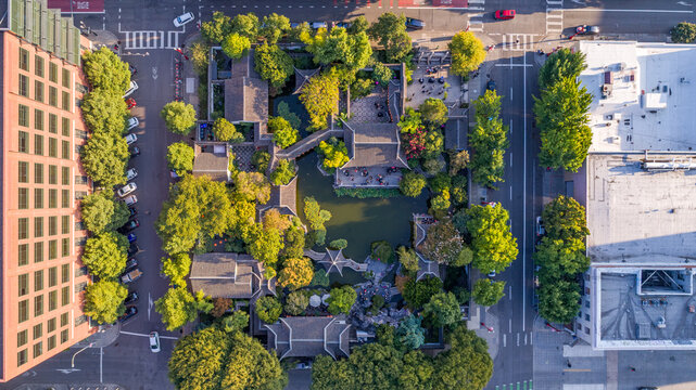 Aerial view of the Lan Su Chinese Garden, a tranquil oasis where traditional architecture meets lush greenery, framed by city streets, Portland, Oregon, United States.