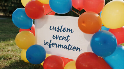 Colorful balloons surrounding event sign