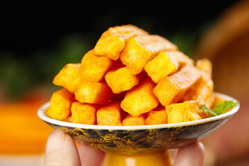 Crispy Roasted Groundnut Strips Snack in Hand with Decorative Bowl