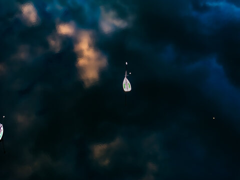 Aerial view of the Charles River reflecting a dark sky with some clouds and light, Boston, Massachusetts, United States.