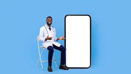 A healthcare worker in a white coat sits on a chair, gesturing towards a large blank smartphone screen. The bright blue background creates a cheerful atmosphere, ideal for sharing health tips.