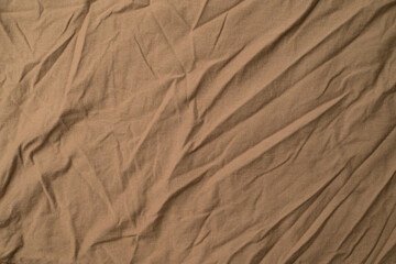 Close-up of light brown fold plain fabric.Light brown fold plain fabric texture and background.
