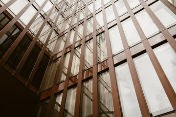 Modern architecture glass interior atrium showing abstract structure with vertical lines and urban building design creating dynamic architectural background