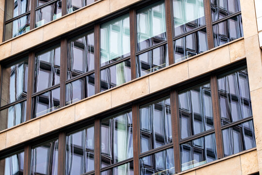 Modern urban architecture facade with window grid pattern on office building creating abstract design background with contemporary city structure