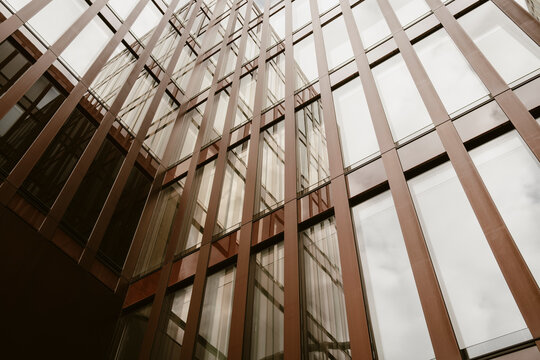 Modern architecture glass interior atrium showing abstract structure with vertical lines and urban building design creating dynamic architectural background