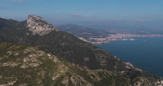 Aerial view of the coastal landscape with mountains meeting the sea, showcasing the village of Erchie, Amalfi Coast, Italy.
