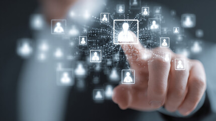 Human hand pressing a glowing icon, representing recruitment and technology