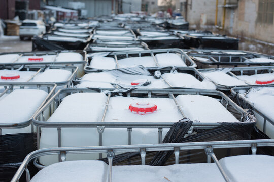 A lot of plastic containers with chemicals stand in a row. Chemicals for the manufacture of paralon in liquid form