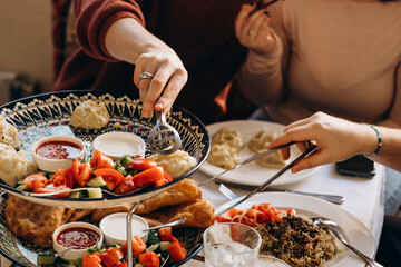 Friends enjoying traditional Caucasian dishes in cozy restaurant.