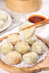 Steamed Asian Dumplings with Chopsticks and Dipping Sauce