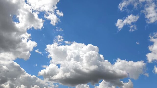 Small grayish clouds move across the sky