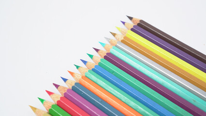 Fototapeta premium A collection of colorful drawing pencils on a clean white surface for art and education.