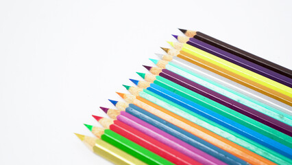 Fototapeta premium A collection of colorful drawing pencils on a clean white surface for art and education.