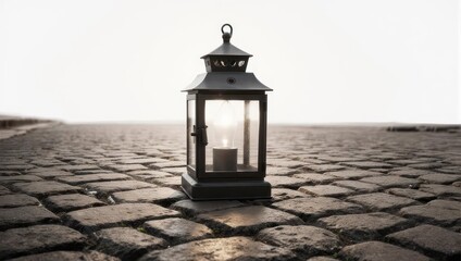 Lantern on cobblestone street with candle glowing in the dusk.