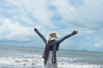 A young woman enjoys a holiday on a beautiful beach in Anyer, Indonesia.
