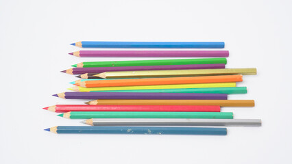Fototapeta premium A collection of colorful drawing pencils on a clean white surface for art and education.