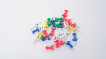 Colorful push pins on white background