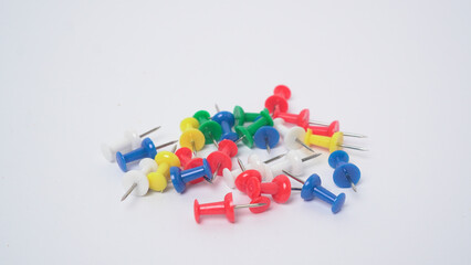 Colorful push pins on white background