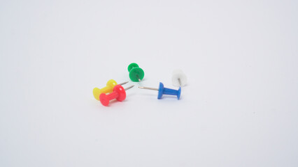 Colorful push pins on white background