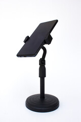 Smartphone or mobile phone in the stand, isolated on white background. Modern Mockup of a mobile phone with a dark display.