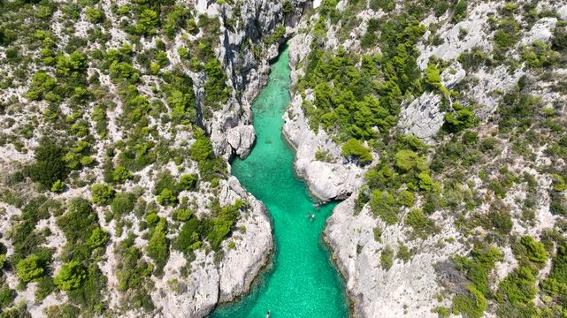 Aerial drone video of of Porto Stenitis famous fjord shaped bay with crystal clear turquoise sea and small beach  ideal for snorkeling visited by small tourist boats, Zakinthos island, Ionian, Greece
