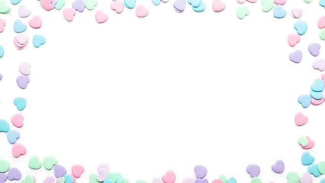 Pastel heart confetti border on white background
