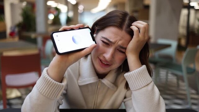 ChatGPT replaces psychological support as distressed young woman cries holding phone sharing emotional pain loneliness and inner struggle during vulnerable moment