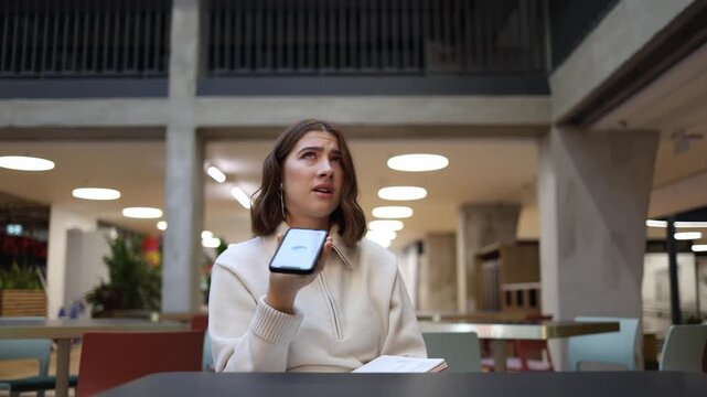 ChatGPT gives an inaccurate response as professional woman reacts emotionally in cafe realizing the AI advice disrupted her work and requires corrections