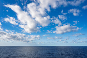 Fluffy clouds, brilliant blue sky, and crystal clear Caribbean waters