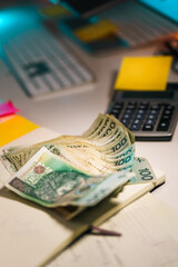 Polish currency cash zloty banknotes office desk calculator. Financial planning budgeting accounting savings expenses paperwork workspace concept business economy