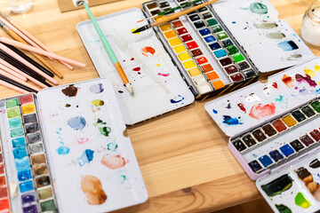 Watercolor painting workshop with art supplies and brushes