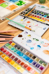 Watercolor workshop creating artwork with paintbrushes and palette