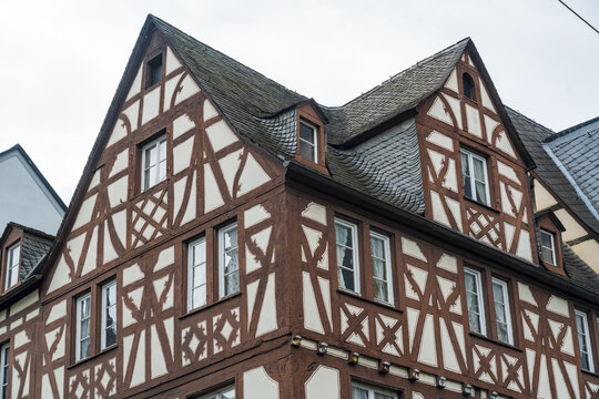 View of a historic building with dark red timber framing contrasting against the white walls under a slate roof, Koblenz Mitte, Rhineland-Palatinate, Germany.
