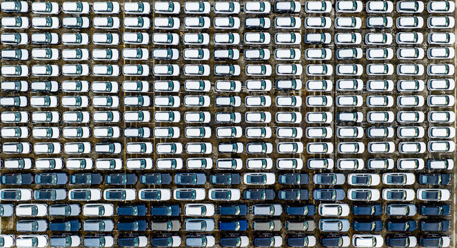 Aerial view of countless cars aligned in neat rows, a geometric symphony of whites and blues at Tanjong Pagar Terminal, Singapore, Singapore.