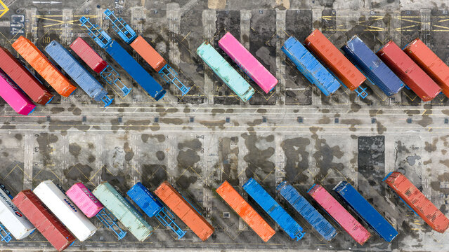 Aerial view of vibrant shipping containers form a colorful mosaic against the stark concrete of Tanjong Pagar Terminal, Singapore, Singapore.