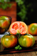 Fresh Dandong Persimmon and Strawberry Tepi Fruits with Water Droplets on Rustic Wood Table